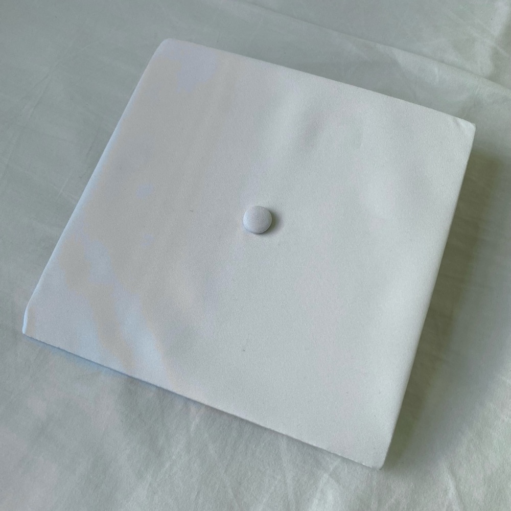 White graduation cap and gown